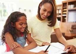 Mom and young girl reading educational material